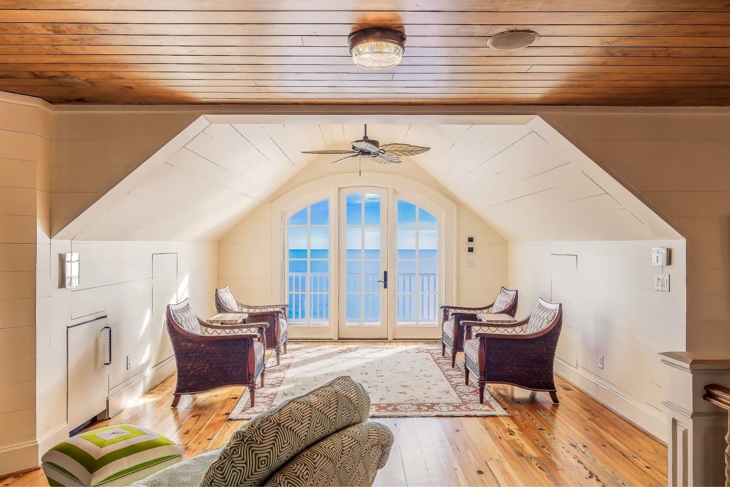 Sunlit luxury hotel suite with ocean view balcony doors