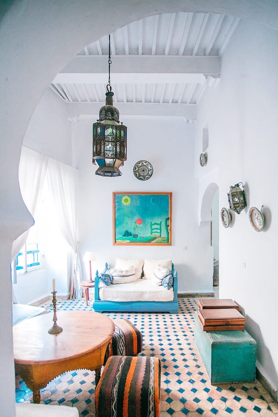 Standard Room lounge with bright white arches and coastal decor
